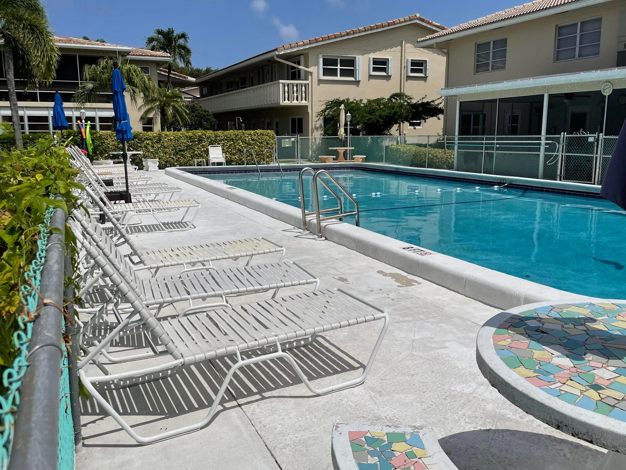 2131 Northeast 42nd Court, Unit 210E Lighthouse Point, FL 33064 - Photo 20 of 22 a view of a house with backyard and sitting area