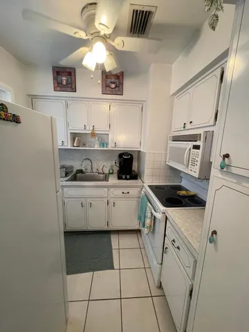 a kitchen with stainless steel appliances a stove a sink and a refrigerator