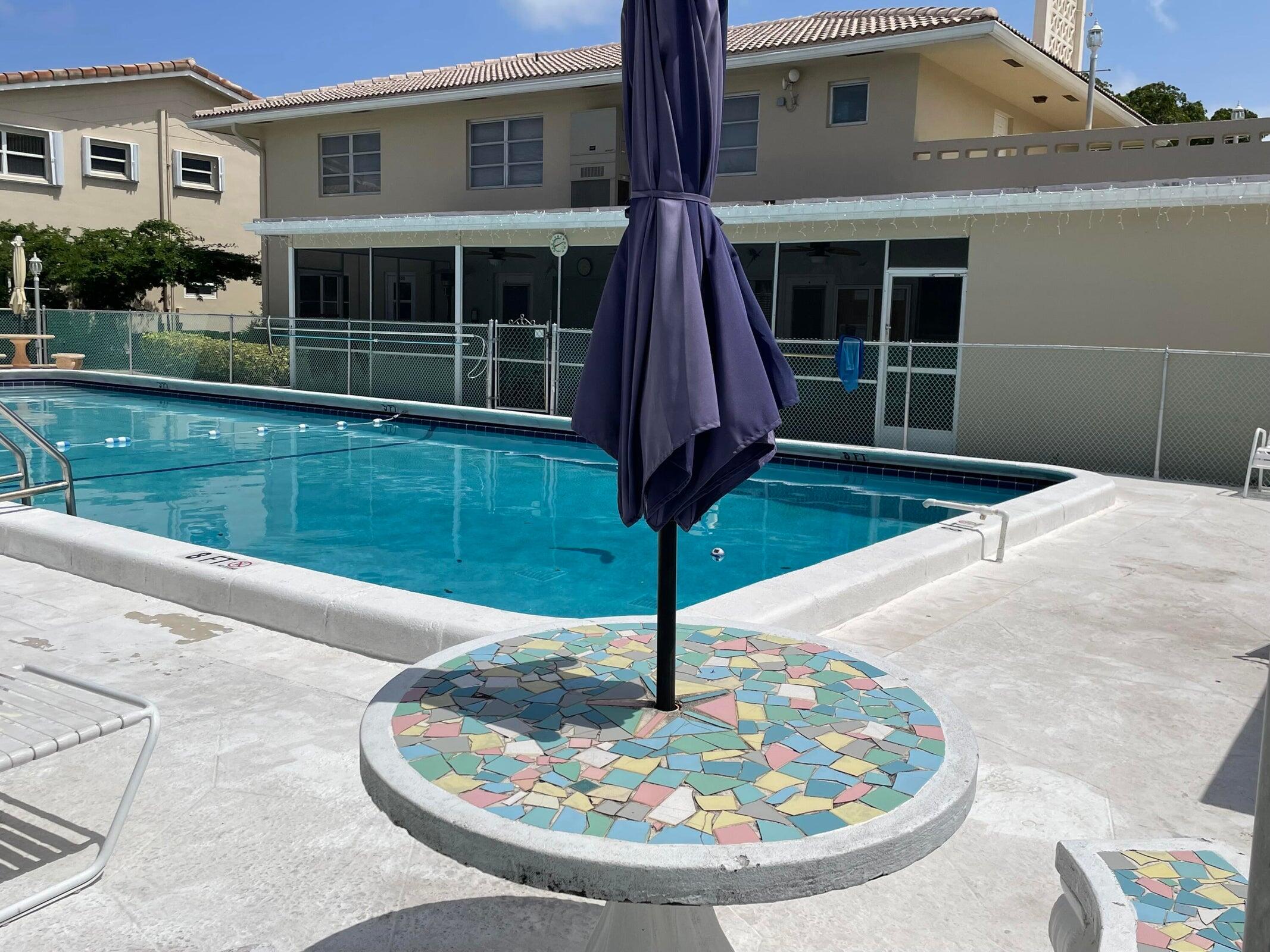 2131 Northeast 42nd Court, Unit 210E Lighthouse Point, FL 33064 - Photo 21 of 22 a house view with a garden space