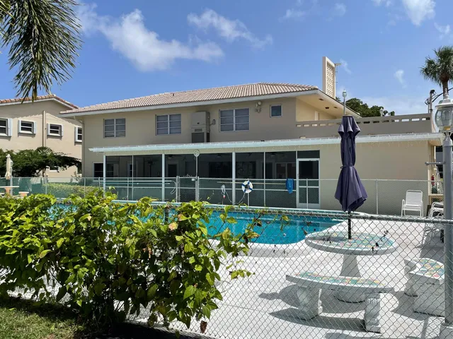 a front view of a house with garden and parking