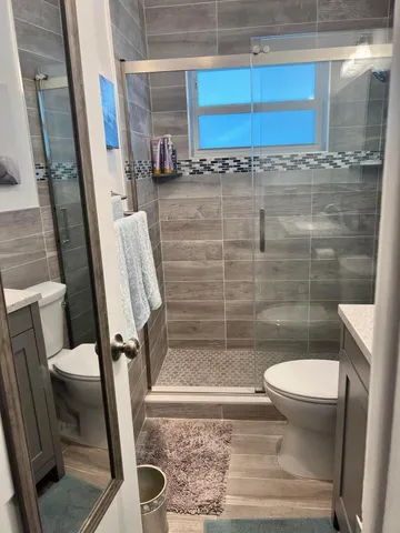a bathroom with a toilet and a shower