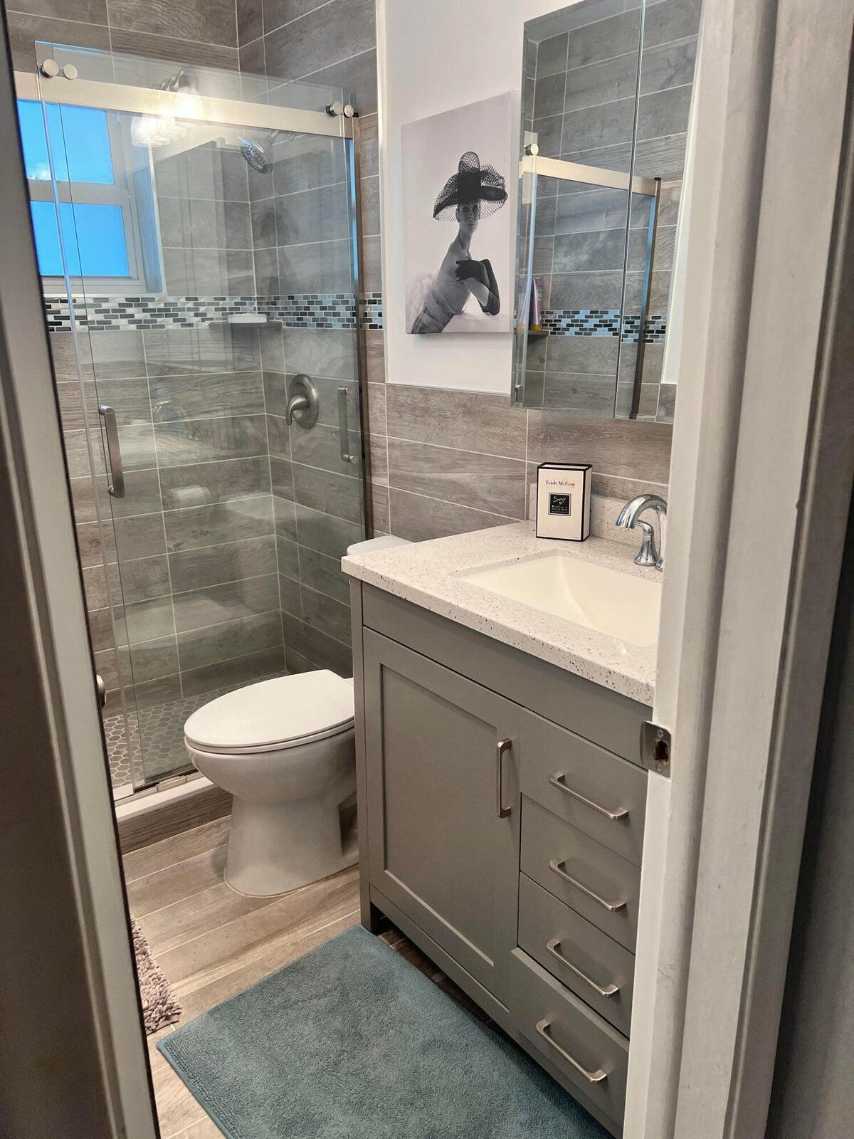 2131 Northeast 42nd Court, Unit 210E Lighthouse Point, FL 33064 - Photo 5 of 22 a bathroom with a sink a toilet and shower