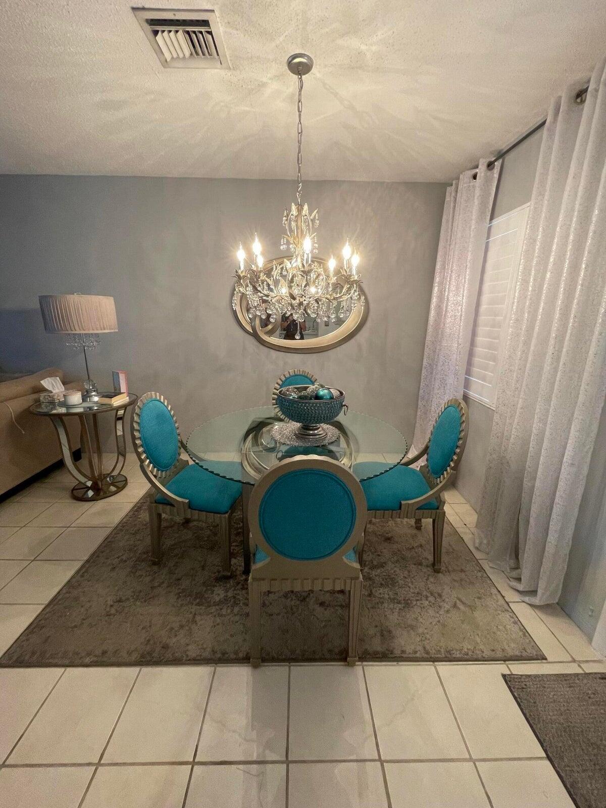 2131 Northeast 42nd Court, Unit 210E Lighthouse Point, FL 33064 - Photo 6 of 22 a dining room with a table and chairs