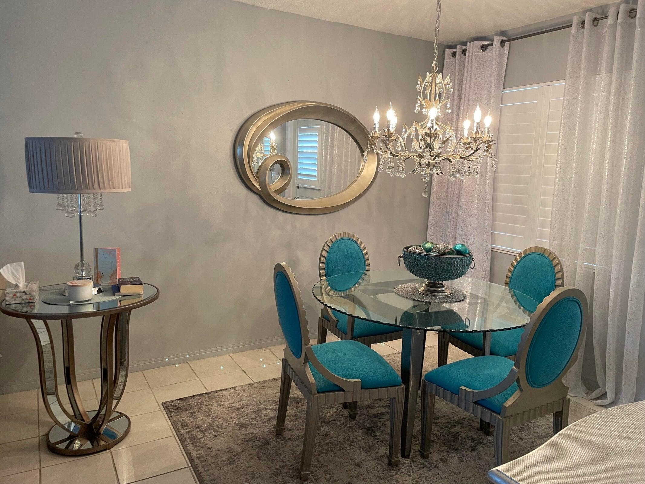2131 Northeast 42nd Court, Unit 210E Lighthouse Point, FL 33064 - Photo 7 of 22 a view of a dining room with furniture and chandelier
