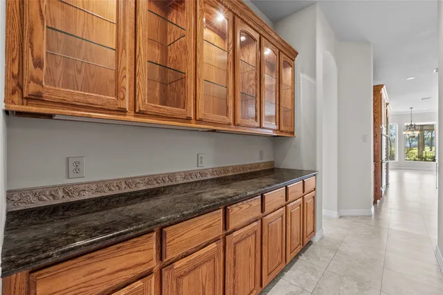 a large kitchen with stainless steel appliances granite countertop a sink and cabinets