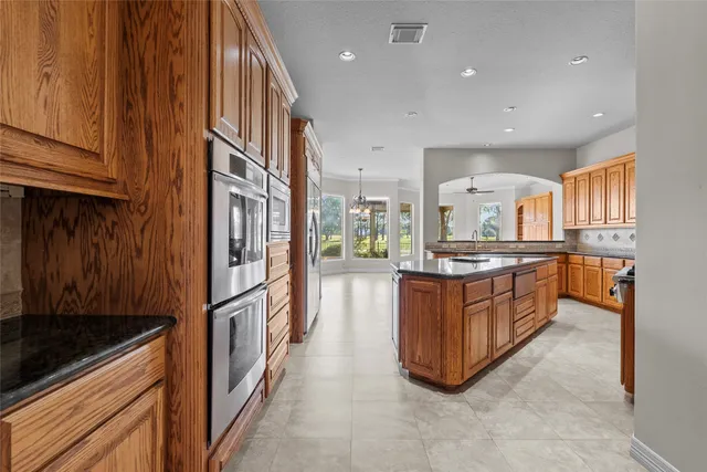a kitchen with stainless steel appliances granite countertop a stove and a refrigerator