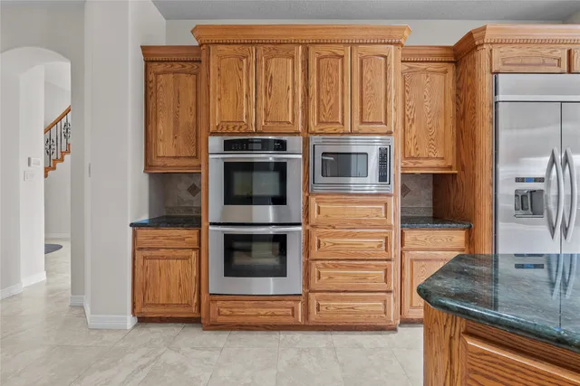 a view of kitchen with granite countertop stove top oven
