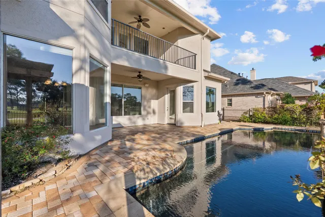a aerial view of a house with a big yard and potted plants