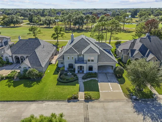 an aerial view of residential houses with outdoor space and lake view
