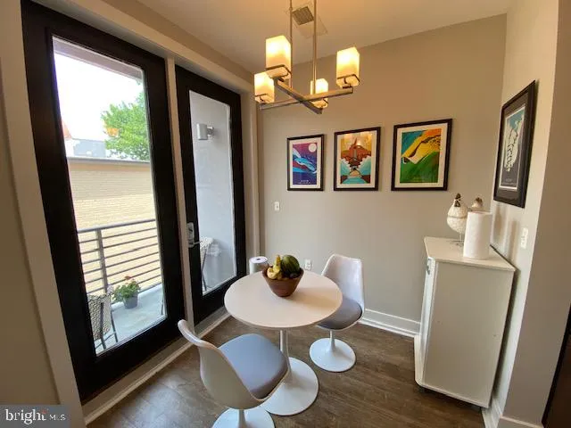 a dining room with furniture a mirror and wooden floor