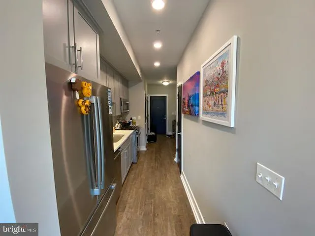 a hallway with painting on the wall