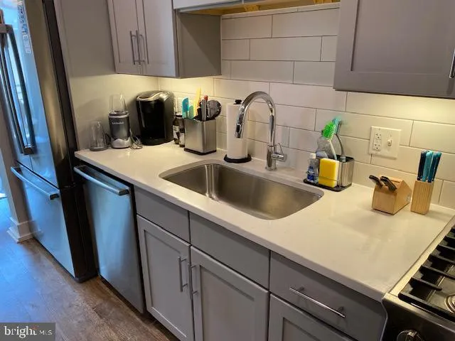 a kitchen with a sink and cabinets