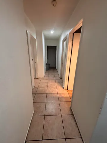 a view of empty room with a fireplace