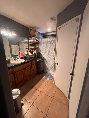 a kitchen with a sink and wooden cabinets