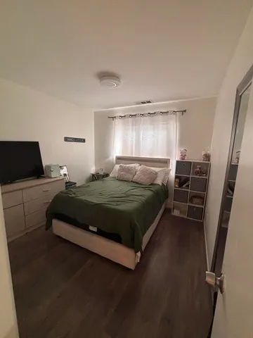 a bedroom with a bed and a window