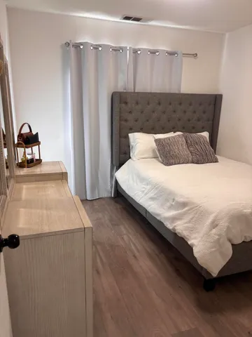 a bedroom with a bed and a mirror