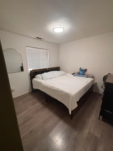 a bed sitting in a room next to a window