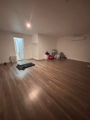 a view of a room with wooden floor