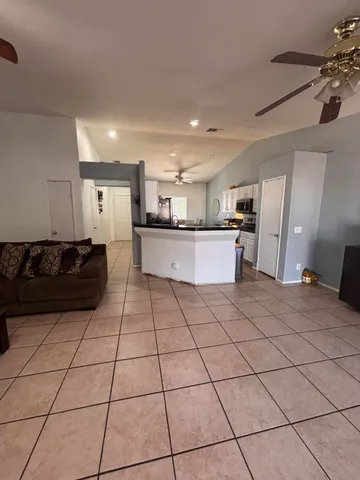 a large kitchen with a stove a sink dishwasher and a refrigerator