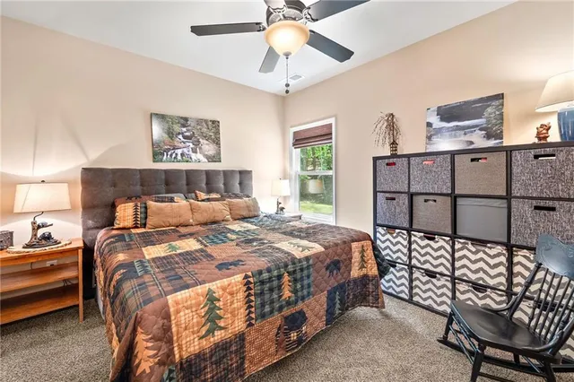 a bedroom with a bed a window and closet