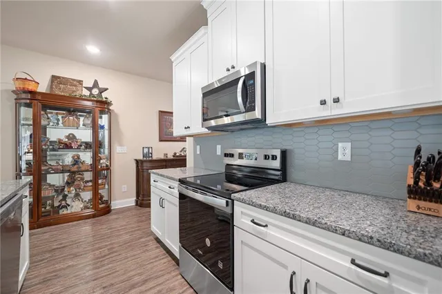 a kitchen with stainless steel appliances granite countertop a stove and a microwave