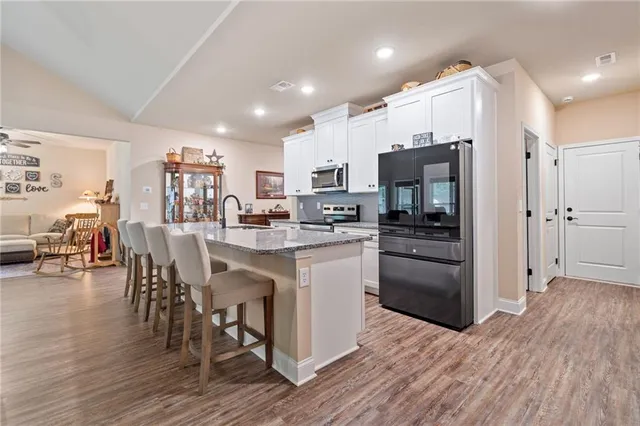 a kitchen with stainless steel appliances a refrigerator stove microwave and cabinets