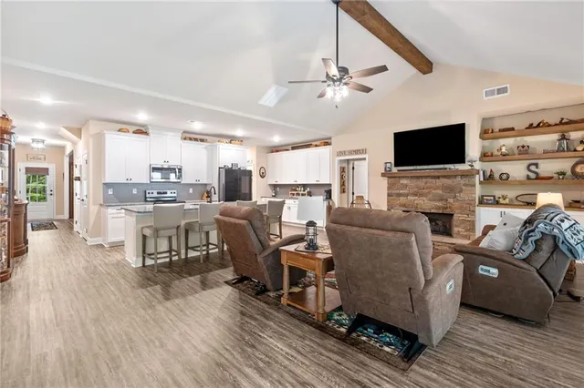a living room with furniture a flat screen tv and a fireplace