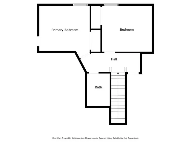 a house with green field in front of it