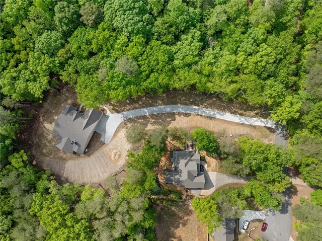 an aerial view of a house with a yard and large tree