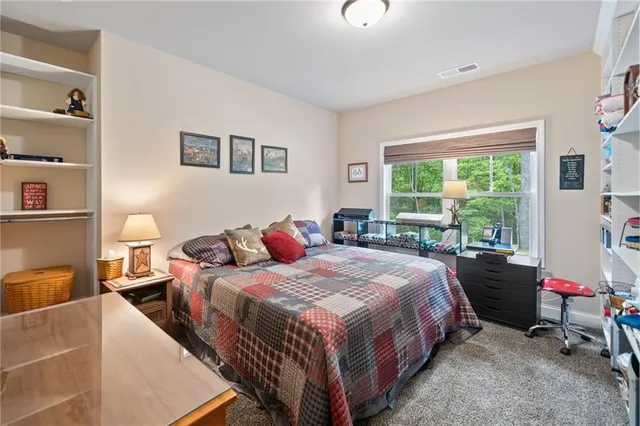 a bed room with a bed and a chair