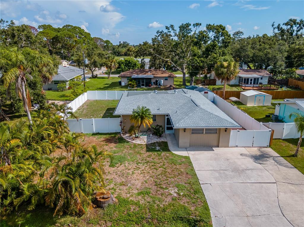 an aerial view of a house with swimming pool garden and patio
