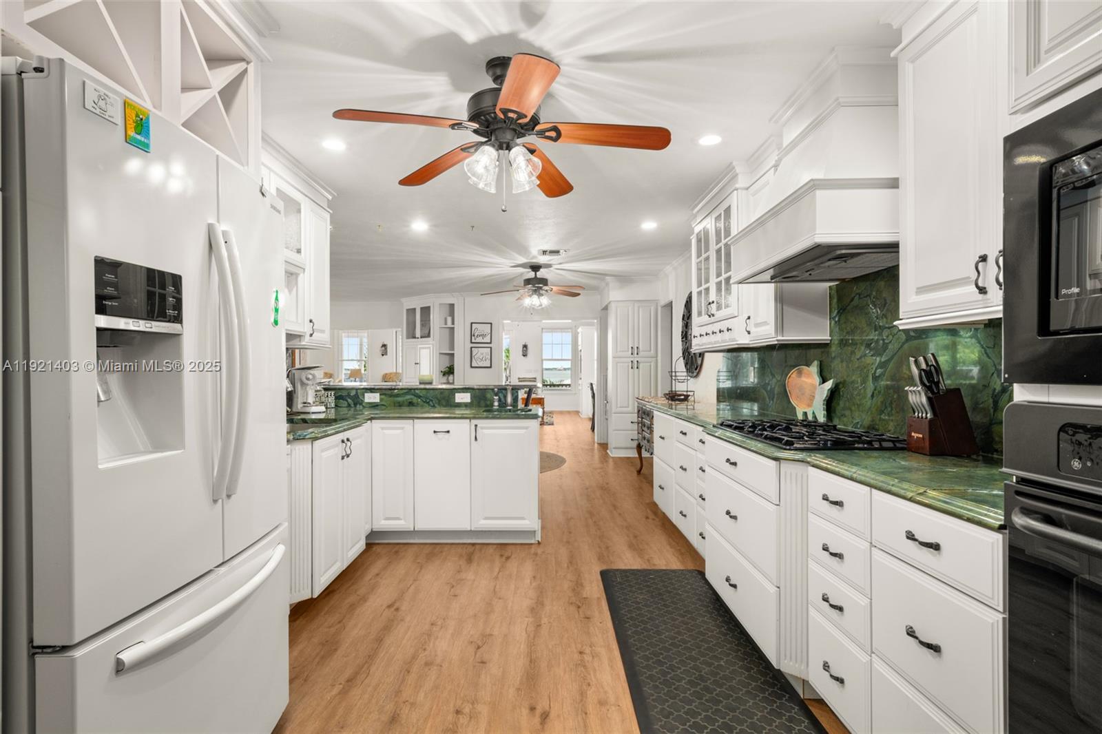 2551 Lakeview Drive Sebring, FL 33870 - Photo 14 of 73 a kitchen with stainless steel appliances kitchen island granite countertop a refrigerator and a sink