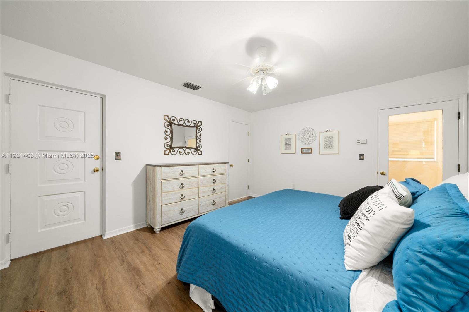 2551 Lakeview Drive Sebring, FL 33870 - Photo 33 of 73 a bedroom with a bed and a chandelier