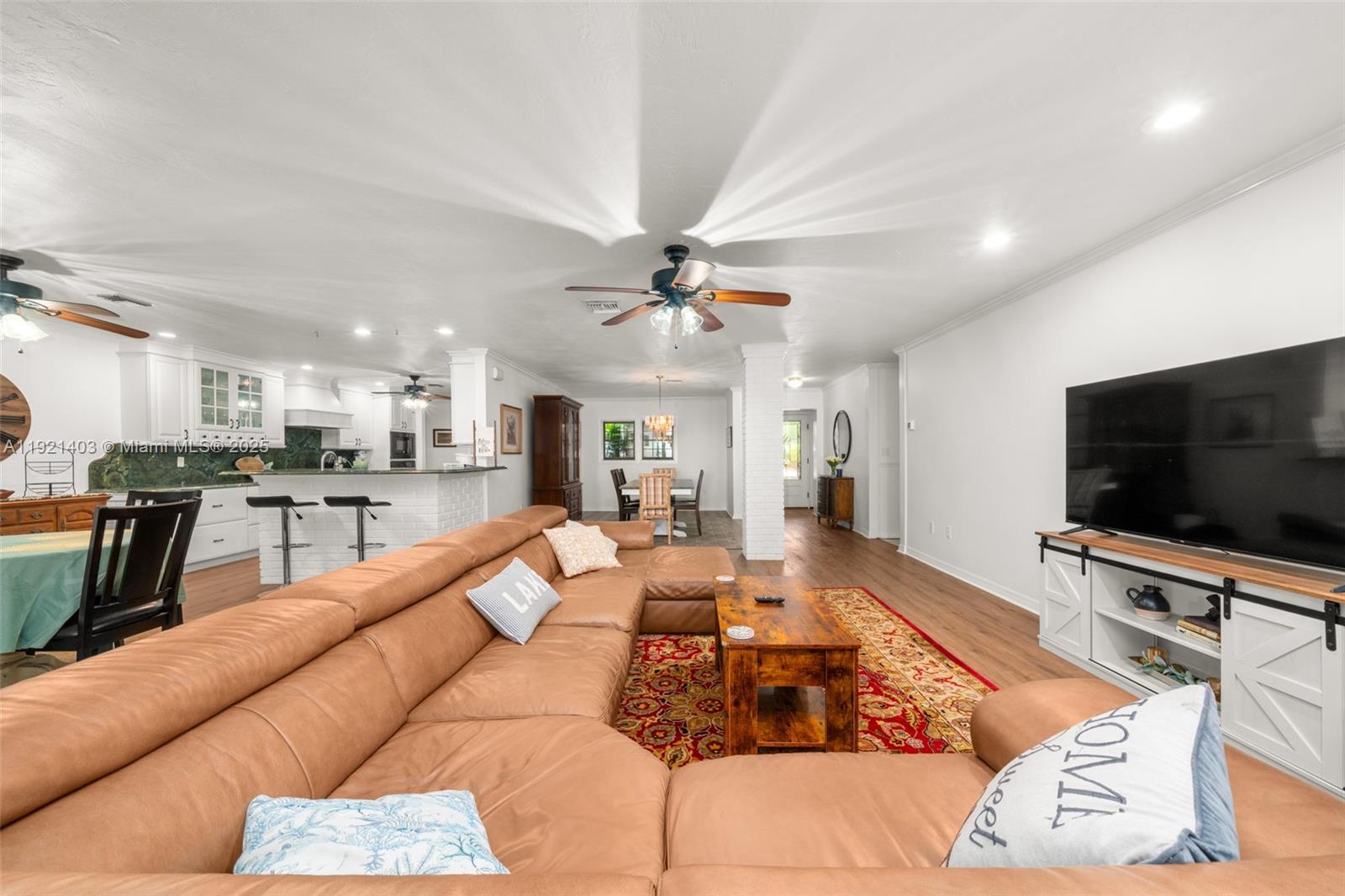 2551 Lakeview Drive Sebring, FL 33870 - Photo 4 of 73 a living room with furniture and a flat screen tv with kitchen view