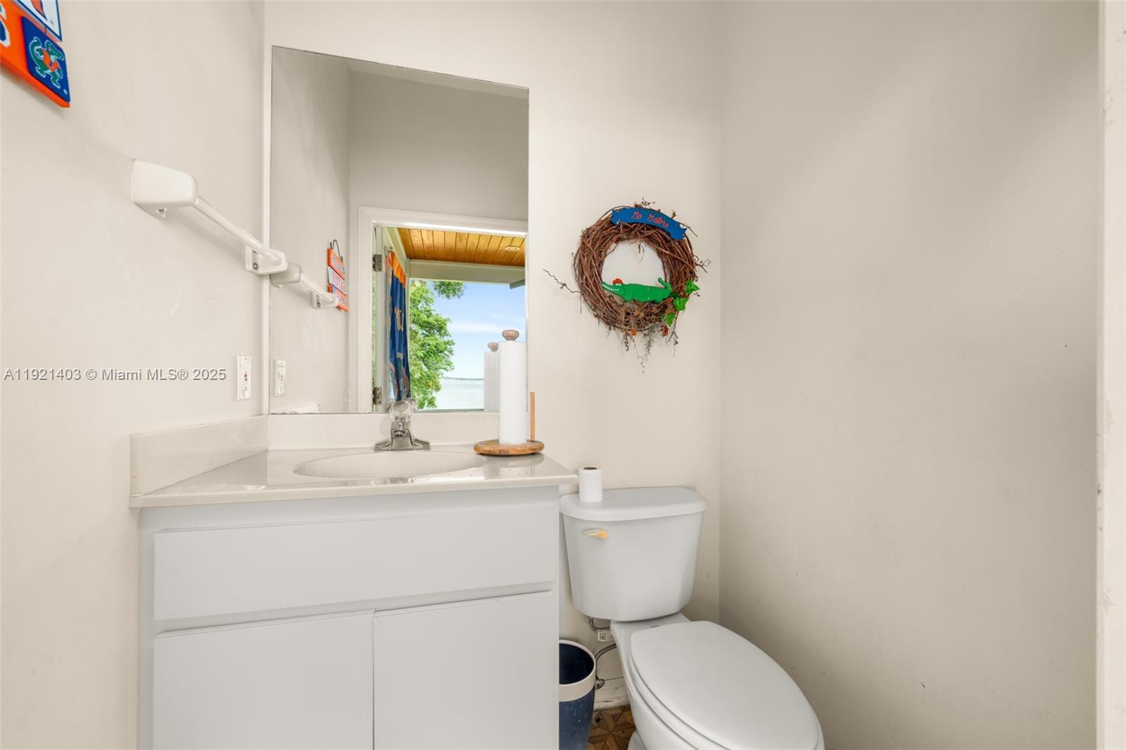 2551 Lakeview Drive Sebring, FL 33870 - Photo 59 of 73 a bathroom with a toilet sink vanity and mirror
