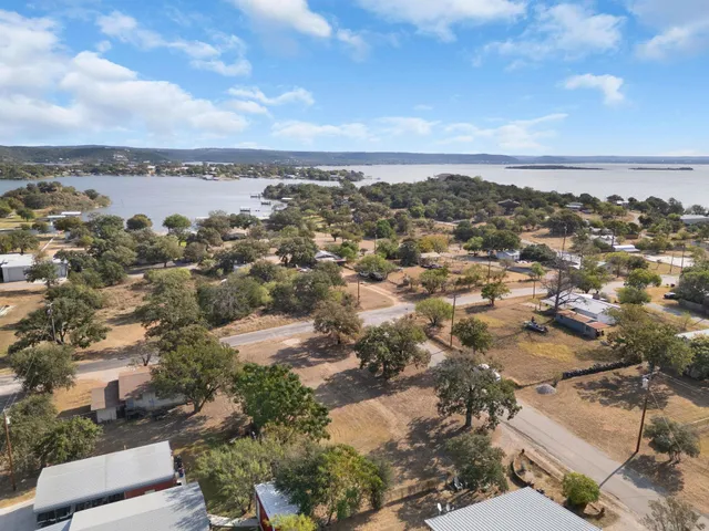 an aerial view of residential building and trees around