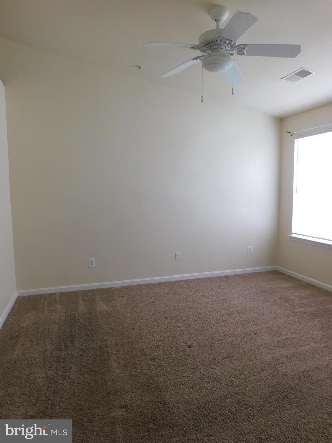 4036 Cutty Sark Road Baltimore, MD 21220 - Photo 17 of 25 an empty room with a window and a fan