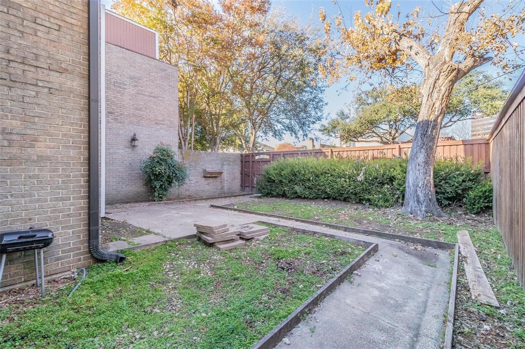 4930 Thunder Road Dallas, TX 75244 - Photo 4 of 23 Brick exterior with an outdoor wall-mounted light fixture