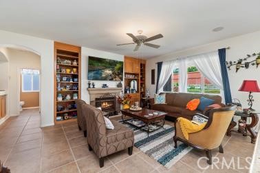 41606 Slice Way Temecula, CA 92591 - Photo 13 of 44 a living room with fireplace furniture and a floor to ceiling window