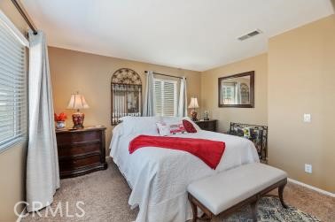 41606 Slice Way Temecula, CA 92591 - Photo 21 of 44 a bedroom with a bed and wooden floor