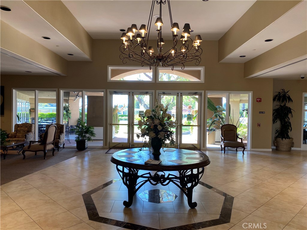 41606 Slice Way Temecula, CA 92591 - Photo 38 of 44 a dining room with wooden floor a chandelier a wooden table and chairs