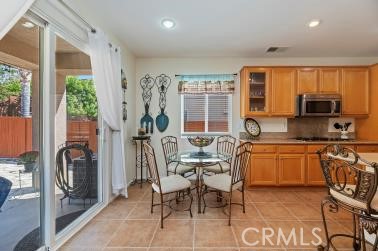 41606 Slice Way Temecula, CA 92591 - Photo 8 of 44 a kitchen with stainless steel appliances granite countertop sink stove top oven dining table and chairs