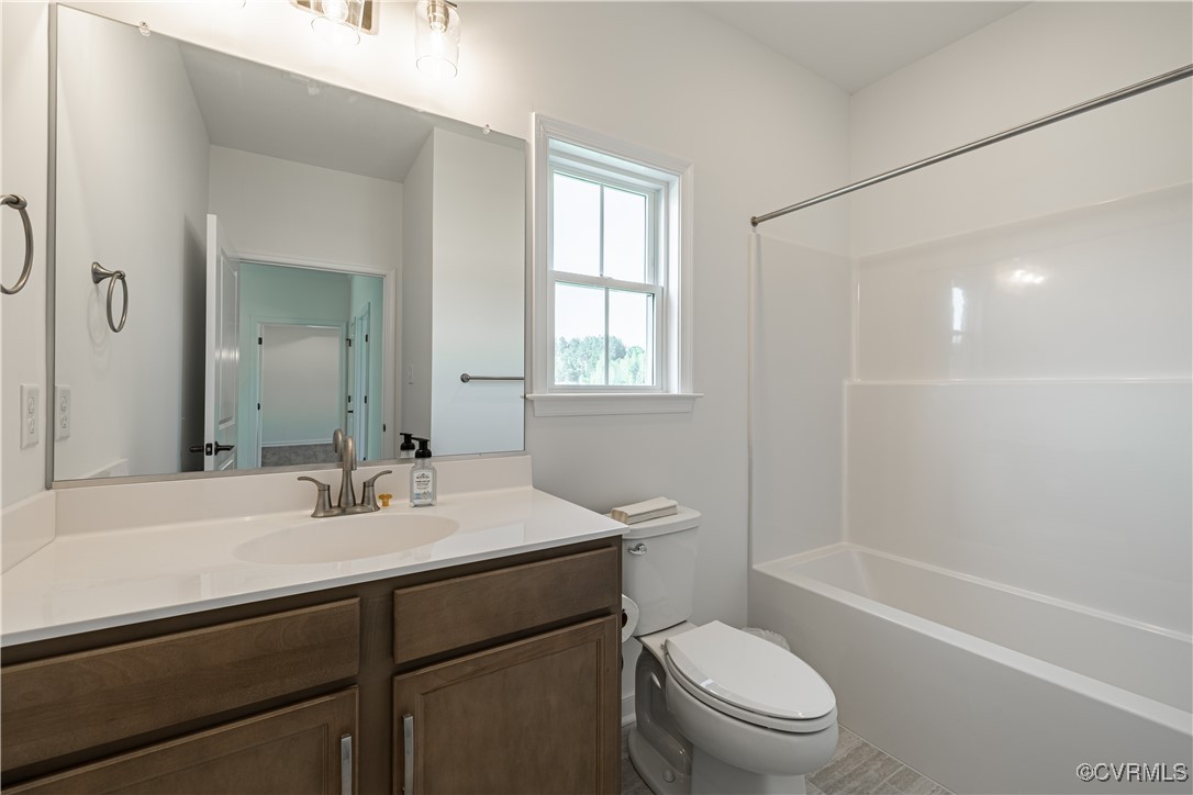 6649 Mayland Ridge Lane Moseley, VA 23120 - Photo 20 of 32 a bathroom with a sink a toilet and shower