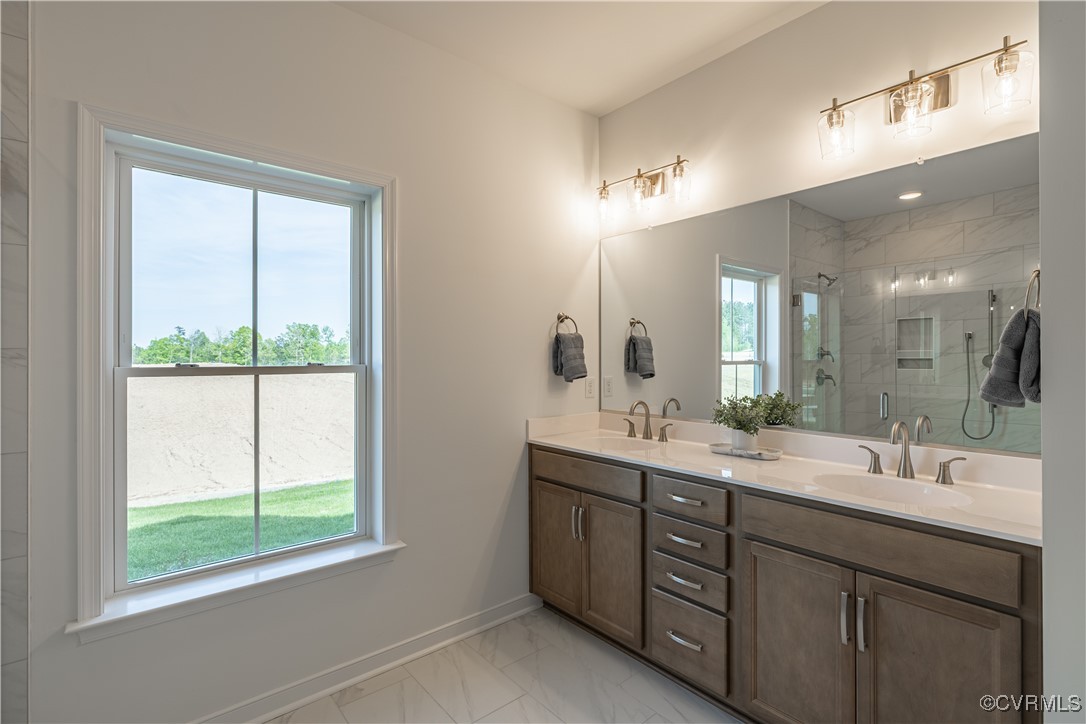 6649 Mayland Ridge Lane Moseley, VA 23120 - Photo 25 of 32 a bathroom with a double vanity sink and mirror with window