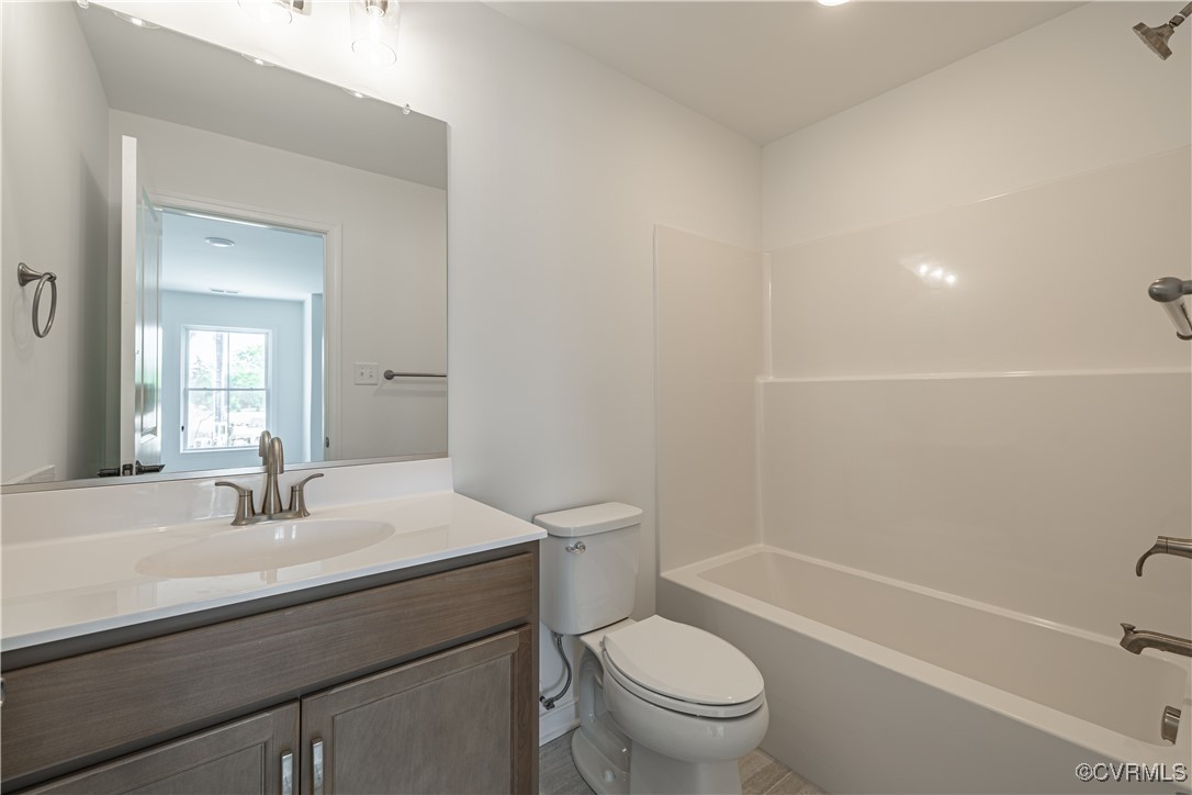 6649 Mayland Ridge Lane Moseley, VA 23120 - Photo 32 of 32 a bathroom with a sink a toilet and shower
