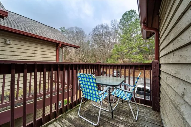 a balcony with table and chairs