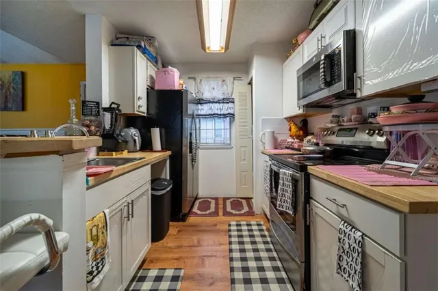 a kitchen with a sink stove and cabinets