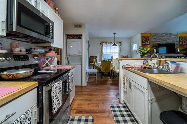a kitchen with stainless steel appliances granite countertop a stove and a sink