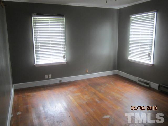 595 Providence Road Roxboro, NC 27573 - Photo 13 of 14 a view of an empty room with wooden floor and a window