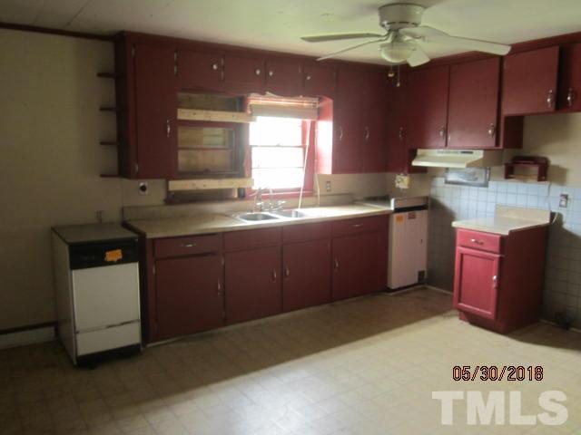 595 Providence Road Roxboro, NC 27573 - Photo 4 of 14 a kitchen with granite countertop a sink stainless steel appliances and cabinets